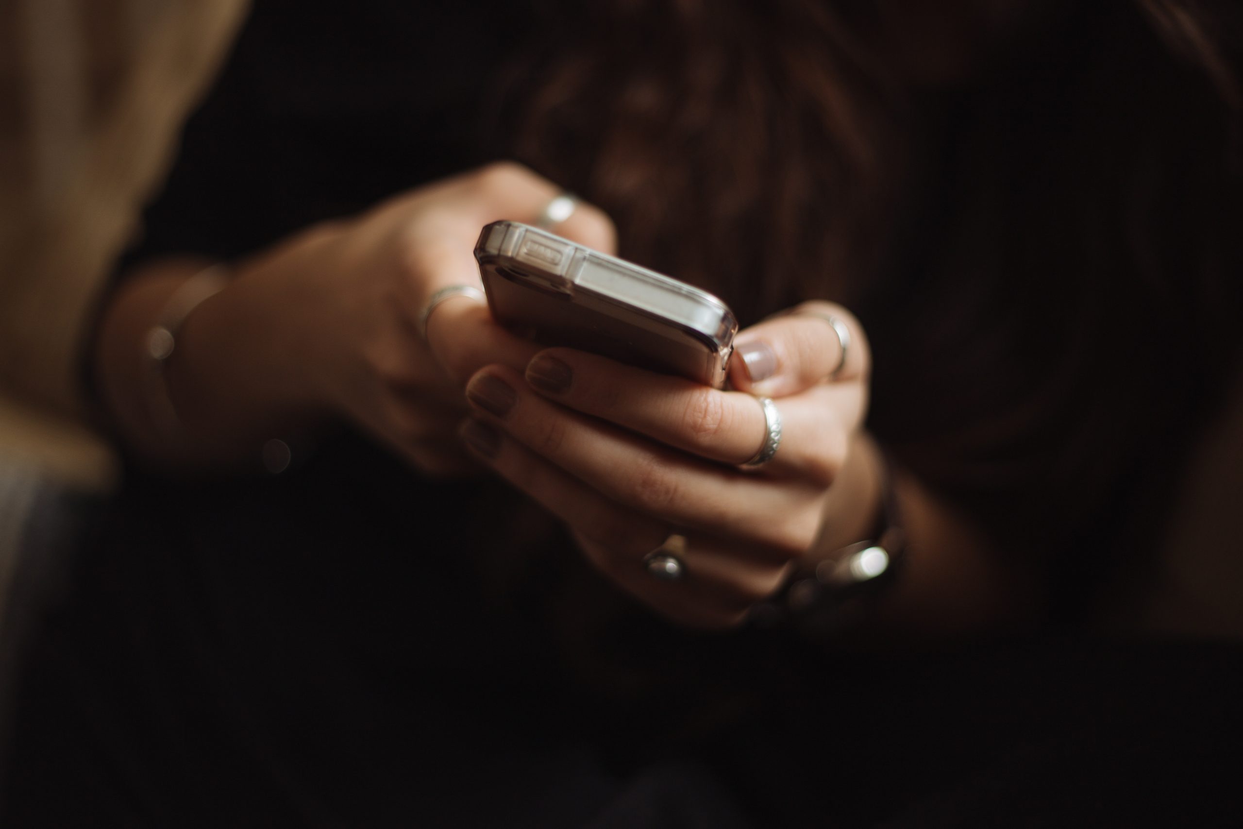 Person holding and looking at a smartphone.